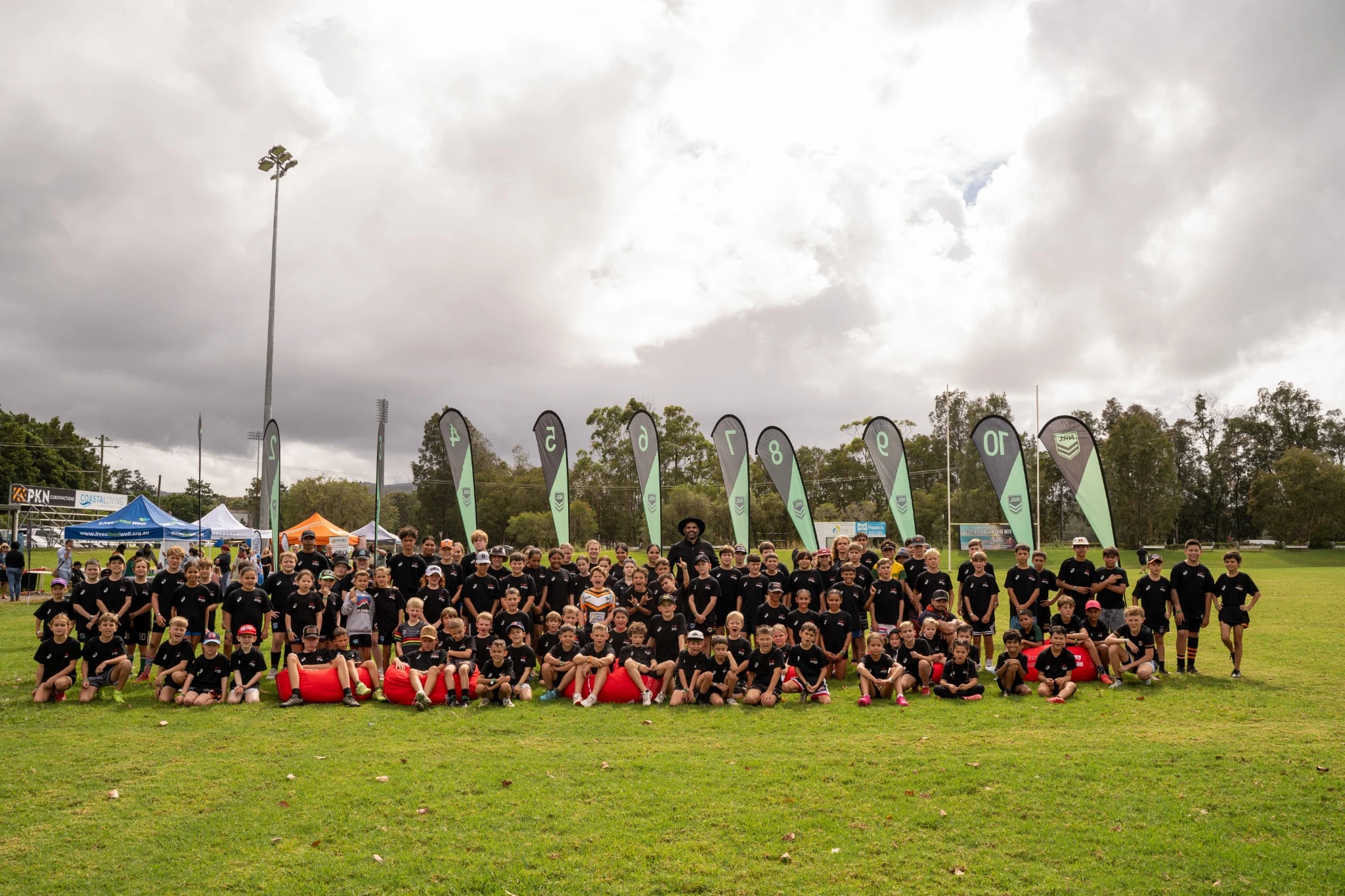 Large group of community youth standing on the field