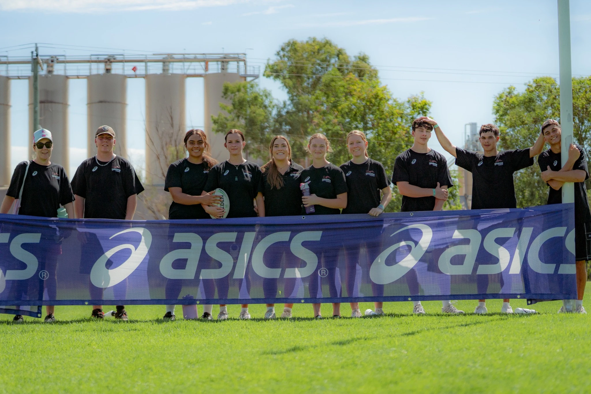 Clinic attendees proudly holding the Goanna Academy banner