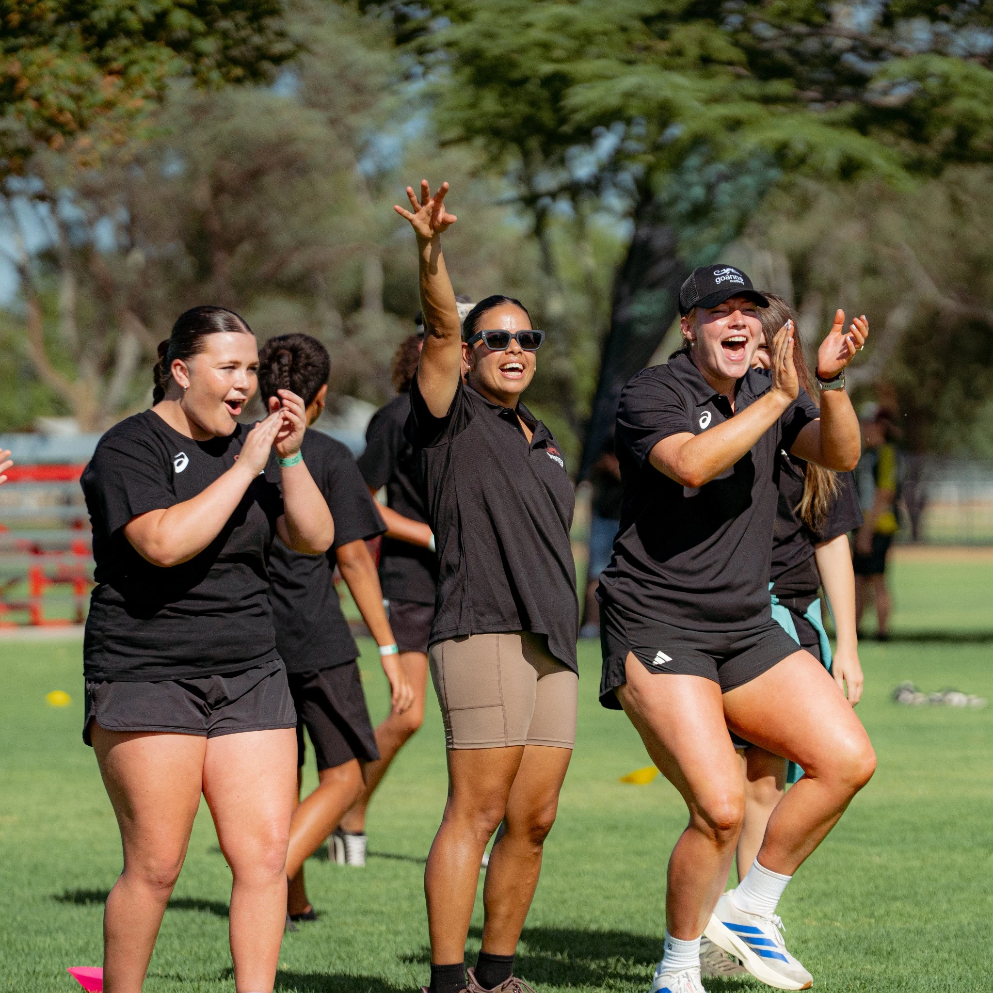 Empower and Elevate - Cheering team on grass